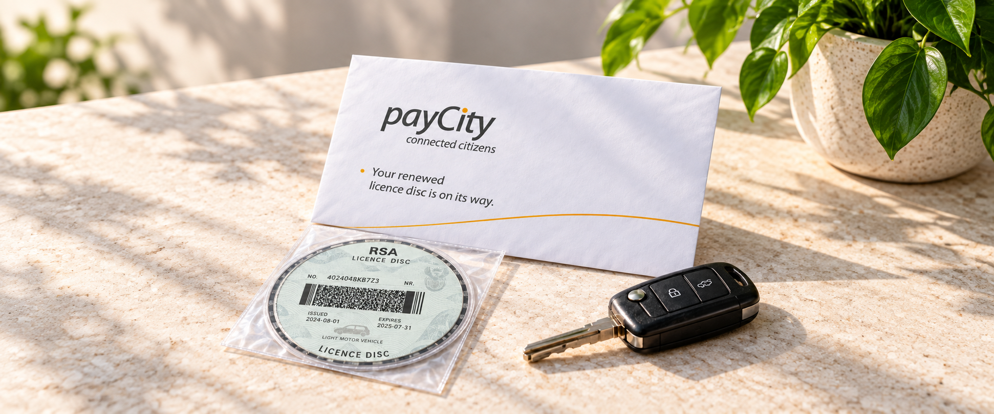 A payCity licence disc delivery envelope with a vehicle licence disc and car key